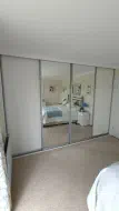2 Wooden panels doors and 2 mirror doors in a brushed silver frame